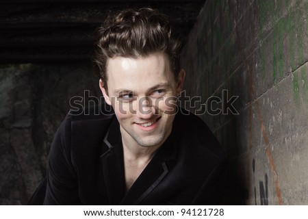 Urban style handsome young man with fifties hairstyle dressed in black