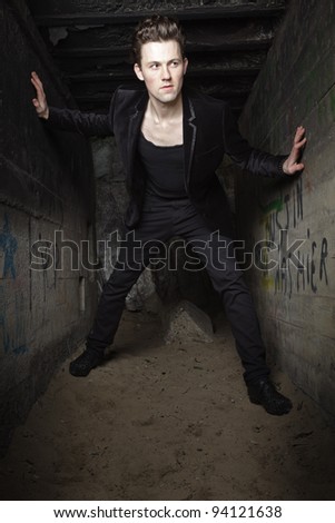 Urban style handsome young man with fifties hairstyle dressed in black