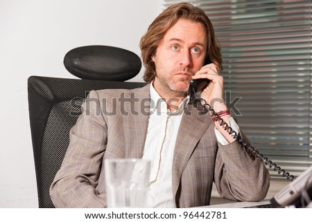 Calling business man long hair in office
