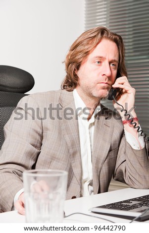 Calling business man long hair in office