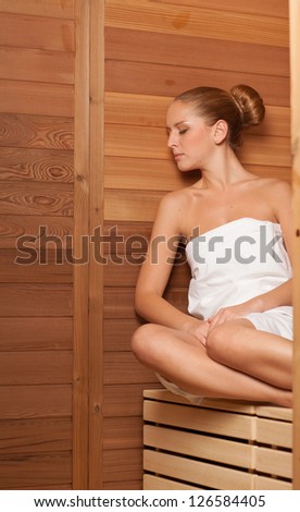 Young woman relaxing in sauna