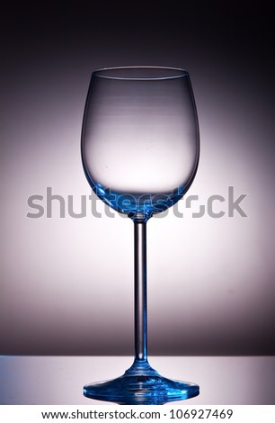 Crystal wine glass with back-lighting giving a blue impression