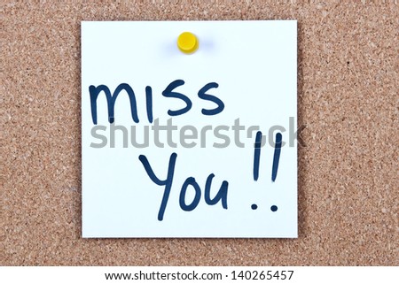 Post it note white with miss you message on cork
