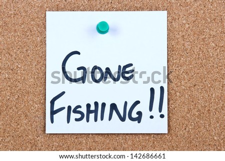 Post it note on wood in white with gone fishing