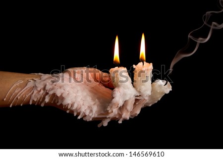 Three candle sticks on fingers burning with wax flow dead