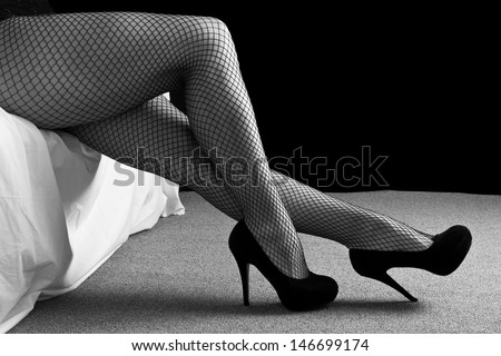 Legs with black high heal shoes and fishnet stockings woman