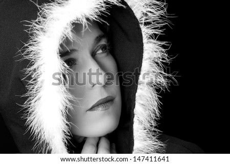 Portrait of sad woman in black cape with white feather artistic conversion