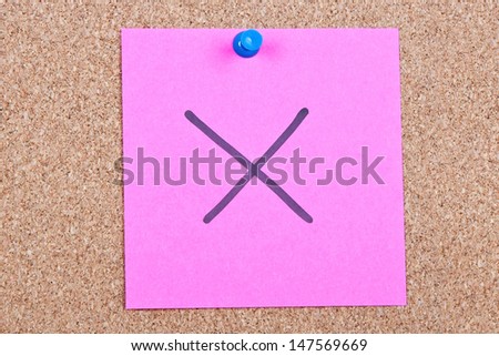 Post it note on wood in pink with wrong cross