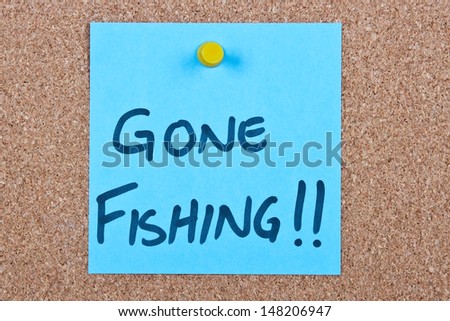 Post it note on wood in blue with gone fishing