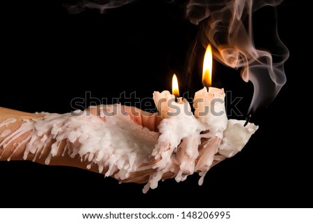 Three candle sticks on fingers burning with wax flow