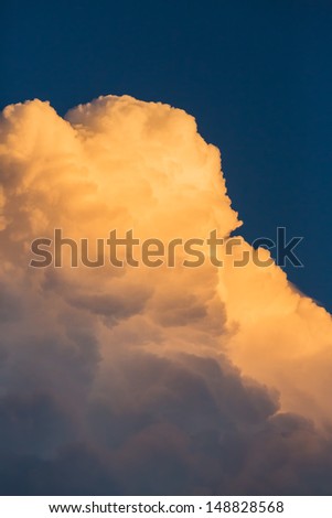 Thunder storm clouds approack in blue sky