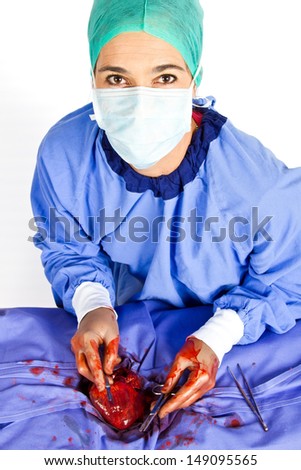 Doctor operating on patient heart in blue with tools
