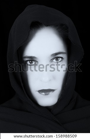 Woman in black cape with sad face and red lips portrait artistic conversion