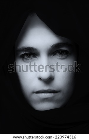 Middle Eastern woman portrait looking sad with a blue hijab artistic conversion