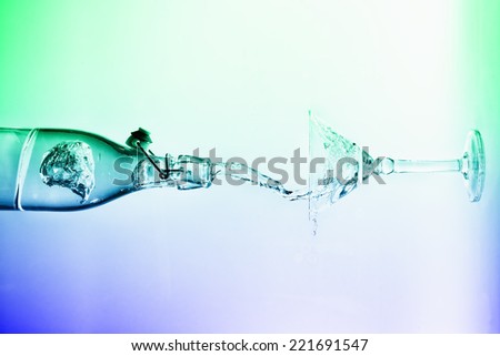 Clear water pour horizontal out of bottle splash into glass with a white back lighting