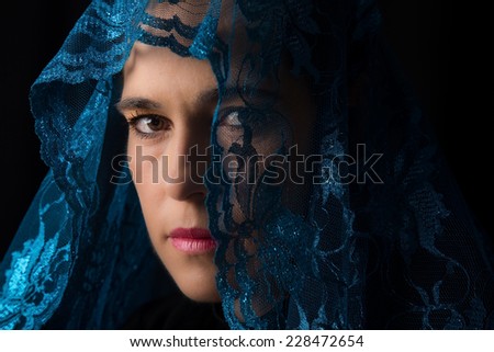Middle Eastern woman portrait looking sad with a blue hijab artistic conversion