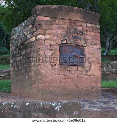 Old outdoor oven of bricks with a iron door