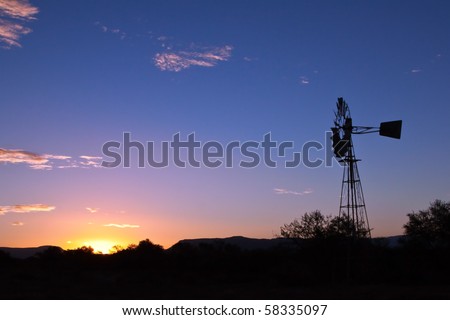 Windmill spinning fast at sunset with lovely orange colours in the Karoo