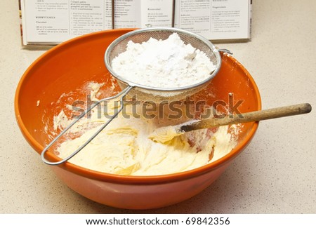 Baking bread in orange bowl mixing flour