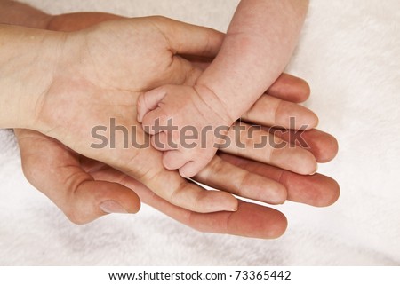 Father mother and baby holding hands family