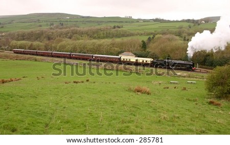 Steam Locomotive 92214 with a train at Irwell Vale Halt on the East Lancashire Railway, England.