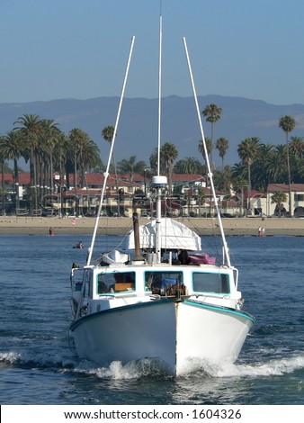 A head on shot of a fishing boat leaving the Santa Barbara marina