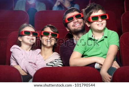 Smiling family in the 3D movie theater