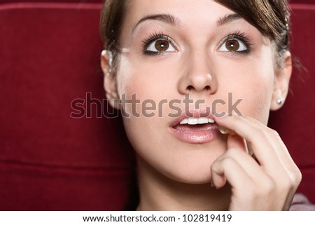 Young woman watching a movie at the cinema