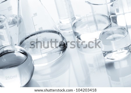 Chemical flask with a blue laboratory test tubes inside, isolated