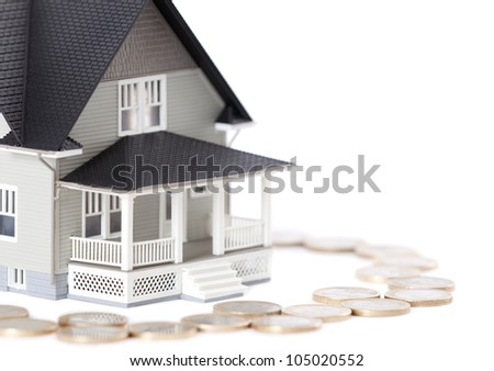 Real estate concept - coins around the house architectural model, isolated