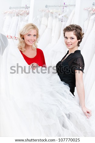 Bride is ready to try this wedding gown on, white background