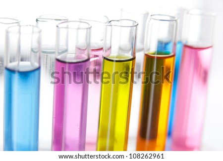 Set of test tubes with a colored liquids in a rack, close-up view