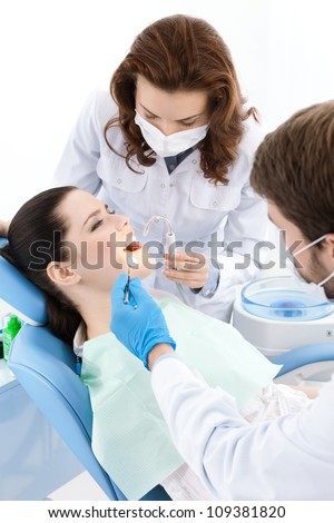 Dentist drills a decayed tooth of the patient