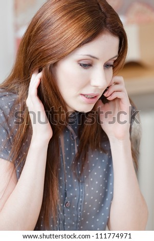 Attractive woman speaks on the telephone at the cafe