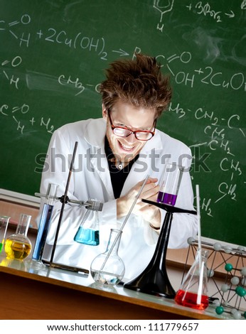 Mad professor rubs hands working in his laboratory