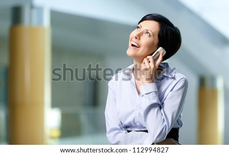 Business woman in business suit talks on mobile. Communication