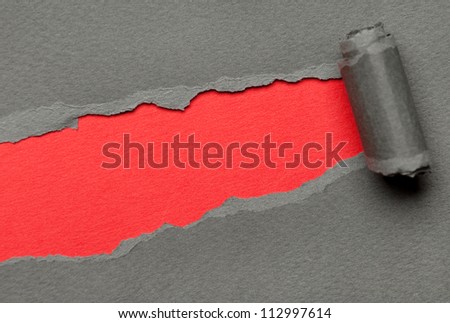 Torn grey paper with red copyspace for your message. Paper roll