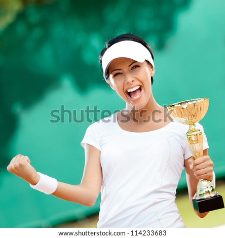 Female tennis player won the cup at the sport competition. Victory