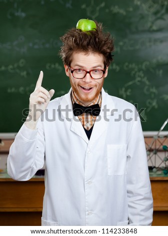 Mad scientist with a green apple on his head shows forefinger
