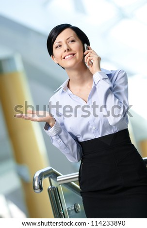 Business woman in business suit talks on mobile. Leadership