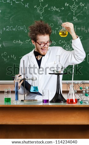 Mad professor shows flat-bottomed flask in his laboratory
