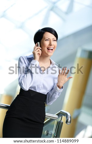 Business woman in business suit talks on phone. Communication