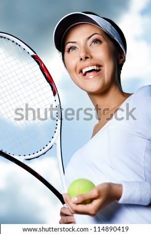 Close up of female tennis player with tennis racket and ball against the sky