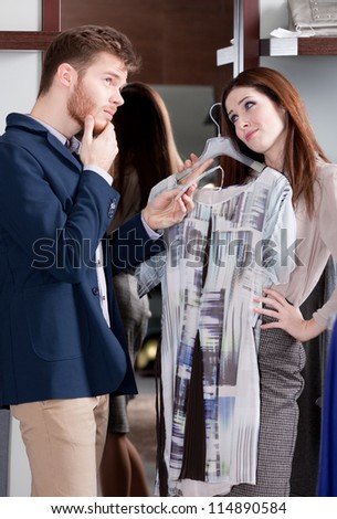 Woman asks her boyfriend to present her a dress
