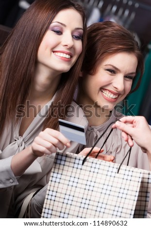 Pretty women pay for purchases with credit card