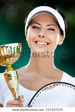 Tennis player won the cup at the sport contest. Victory