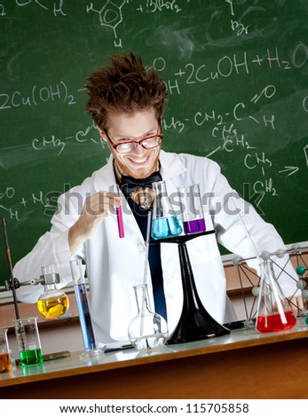 Mad professor holds a vial with red liquid