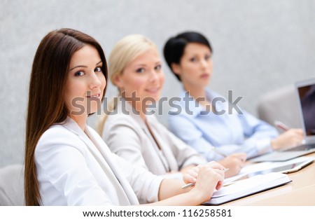 Female colleagues discuss business plan sitting at the meeting hall. Leadership team