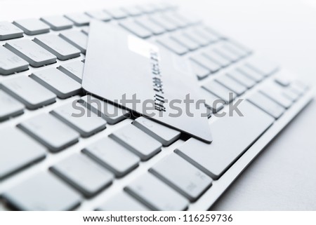 Close up of credit card on a computer keyboard. Concept of internet buying
