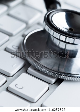 Close up of stethoscope on computer keyboard. Medicine concept